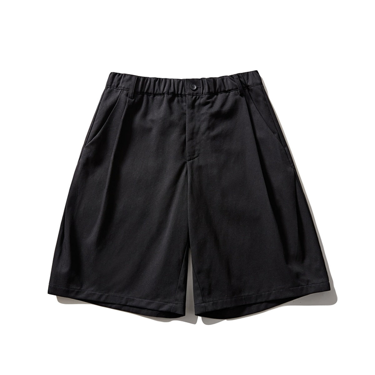 Black pleated wide-leg knee-length shorts with elastic waistband and button, front flat lay