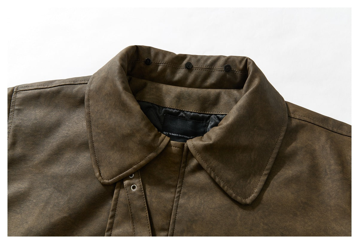 Close-up of the brown jacket’s back collar and upper lining, with the collar folded open.