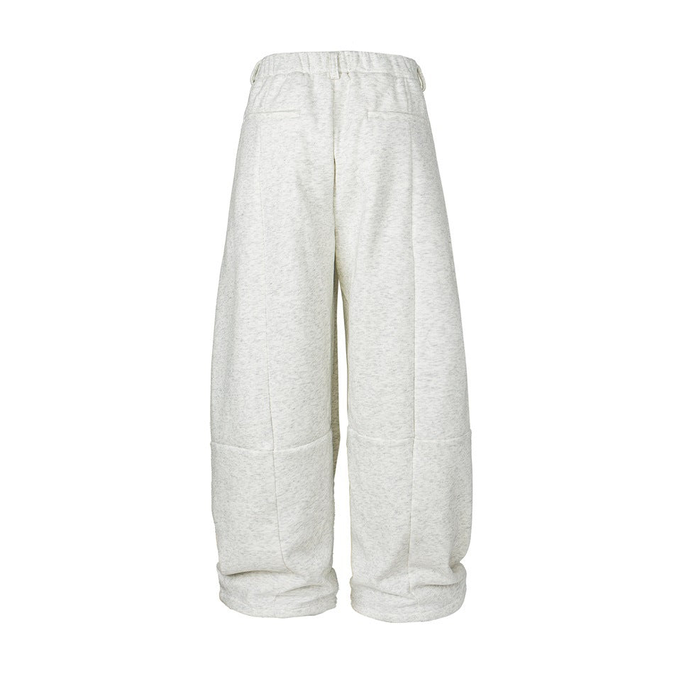 Back view of pale heather-gray wide-leg trousers with rear pockets and folded cuffs.