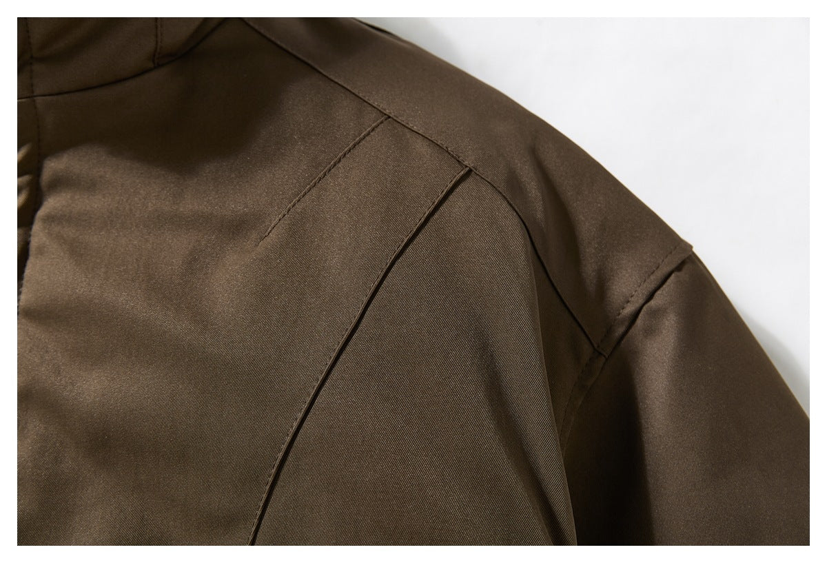 Close-up of the dark brown jacket’s shoulder seams and sleeve construction.