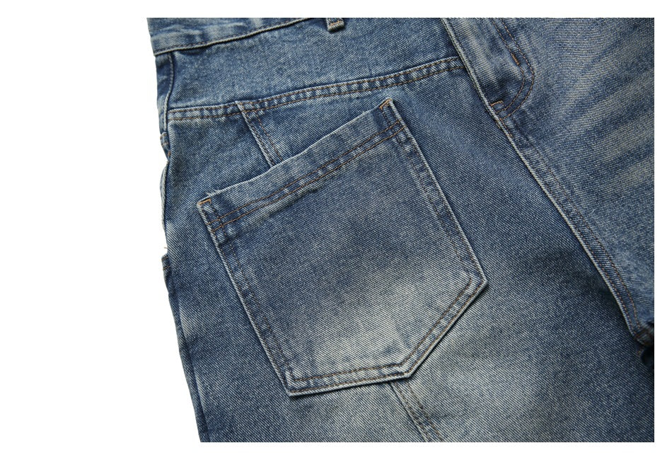 Close-up of blue washed jeans showing a stitched back pocket and the surrounding seams.