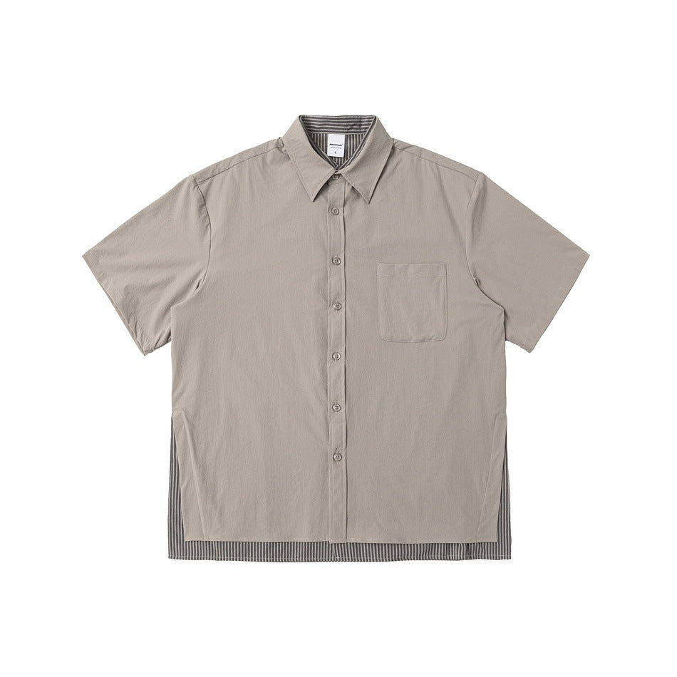 Front view of a taupe short-sleeve button-up shirt with a pointed collar, chest pocket, and striped hem inset.