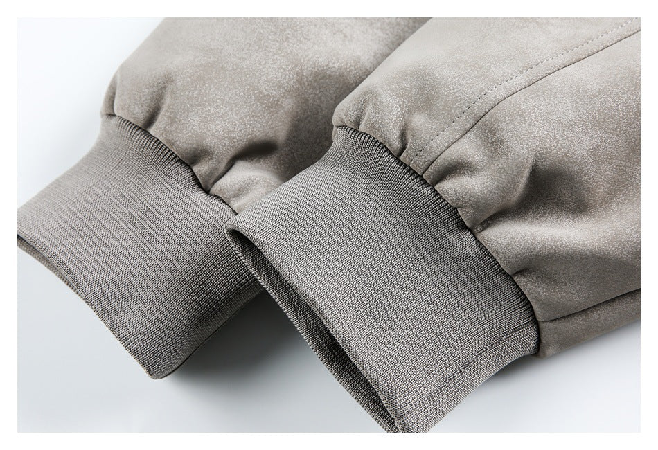 Close-up of two light gray jacket cuffs with wide ribbed bands and gathered sleeves.