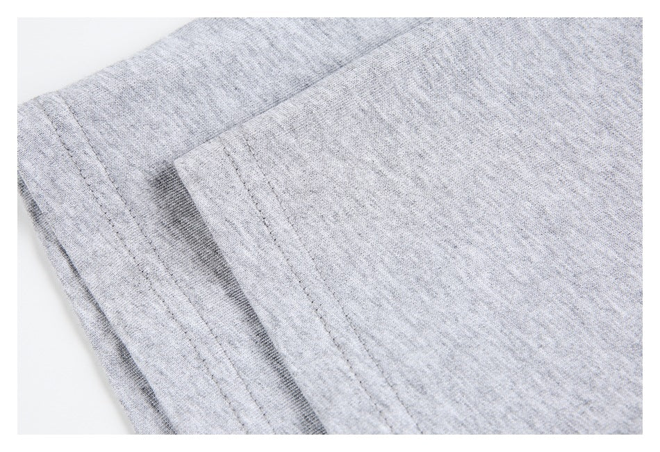 Close-up of light heather gray garment fabric and stitched folded edges.