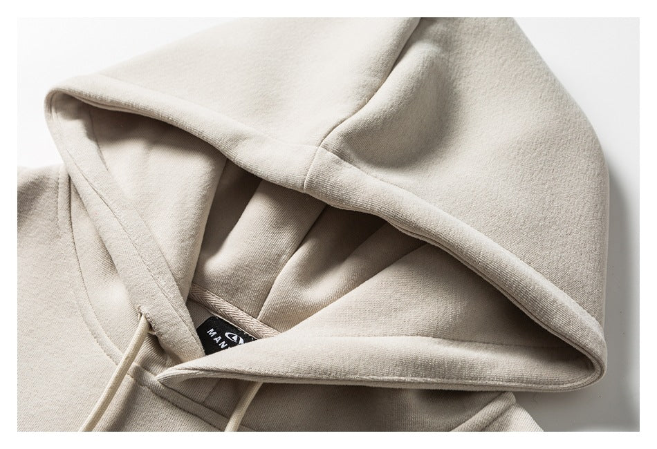 Close-up of an off-white hoodie hood with drawstrings and a visible inner neck label.