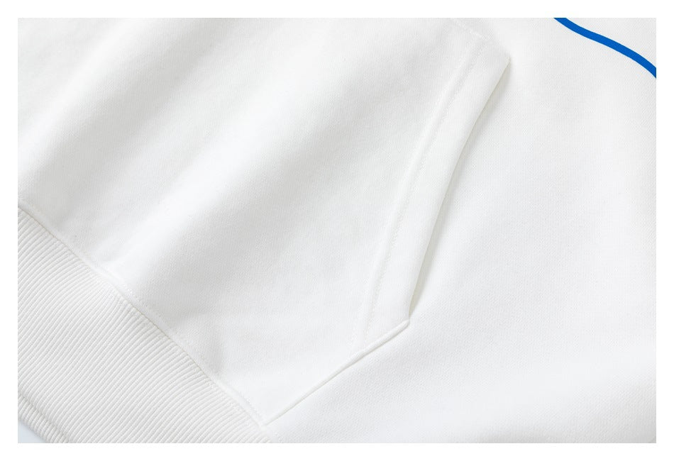 Close-up of the white sweatshirt’s front kangaroo pocket and ribbed lower edge.