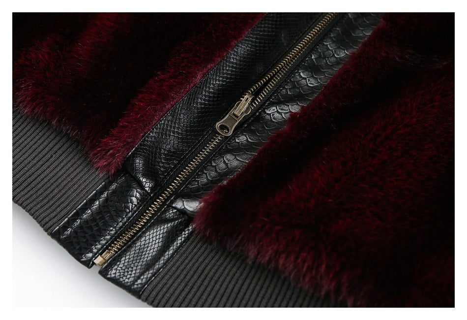 Close-up of burgundy pile, black reptile-embossed trim, a metal zipper and ribbed black edge.