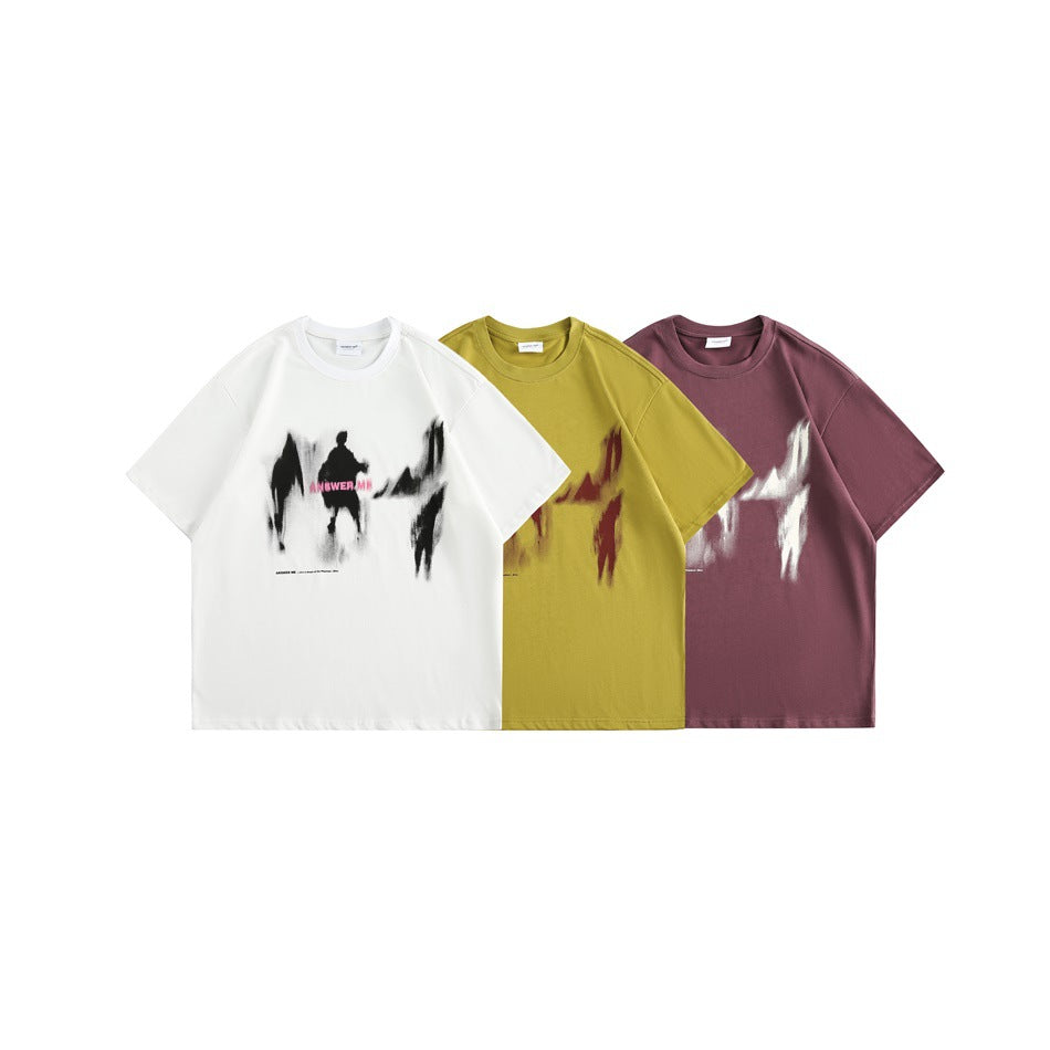 Three short-sleeve graphic T-shirts shown from the front in white, mustard yellow, and burgundy.