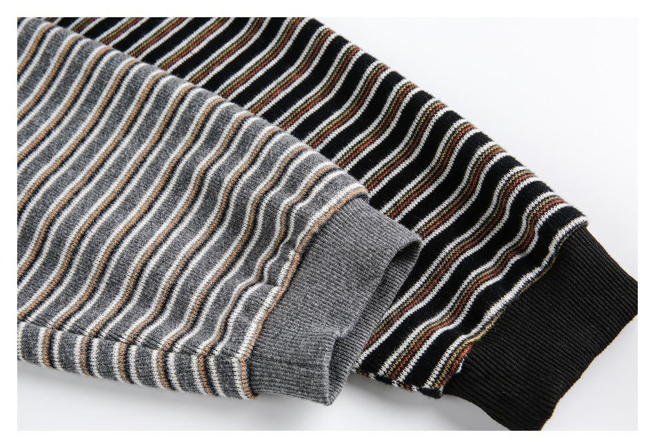 Close-up of gray and black striped knit sleeves with solid ribbed cuffs.