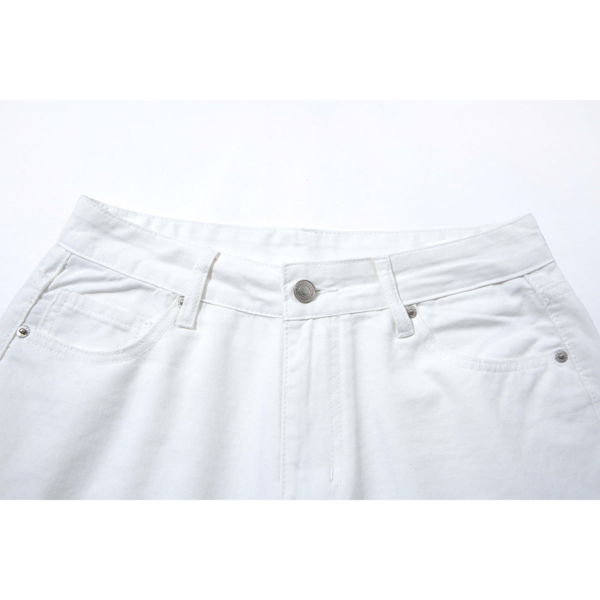 Close-up of white wide-leg pants showing the waistband, button, belt loops and front pockets.
