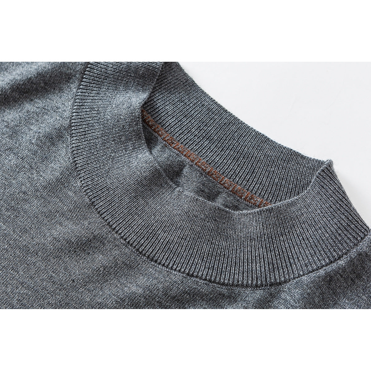 Close-up of a gray knit sweater's ribbed crew neckline and inner seam.