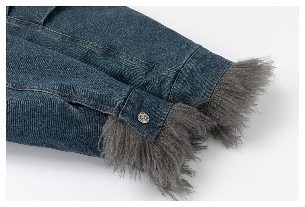 Close-up of denim jacket sleeve cuffs finished with gray shaggy trim and snap tabs.