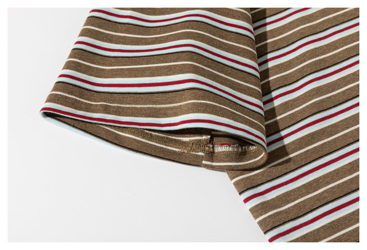 Close-up of the striped T-shirt's sleeve opening and visible stitching.