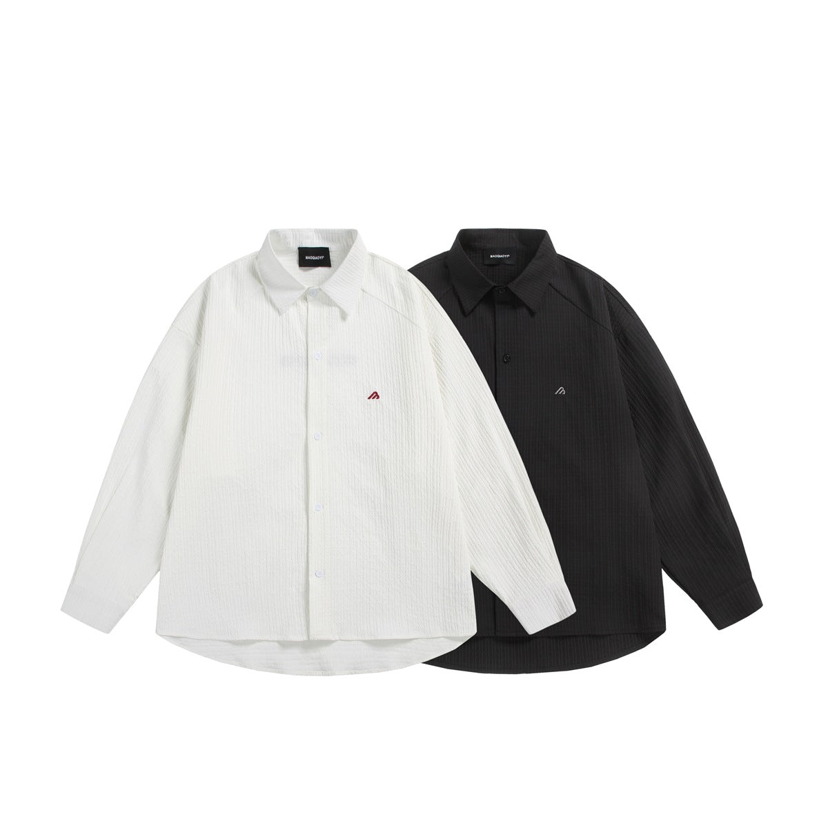White and black long-sleeve button-up shirts with pointed collars and small chest emblems, shown together.