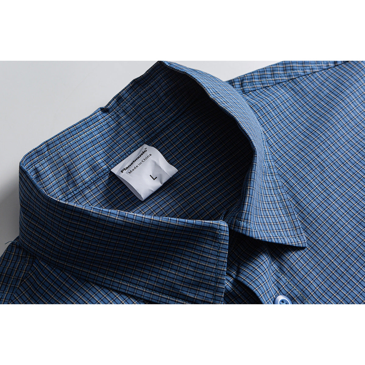 Close-up of a blue plaid shirt collar with an interior label marked size L.