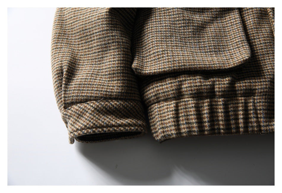 Close-up of the checked jacket's sleeve cuff and gathered lower hem.
