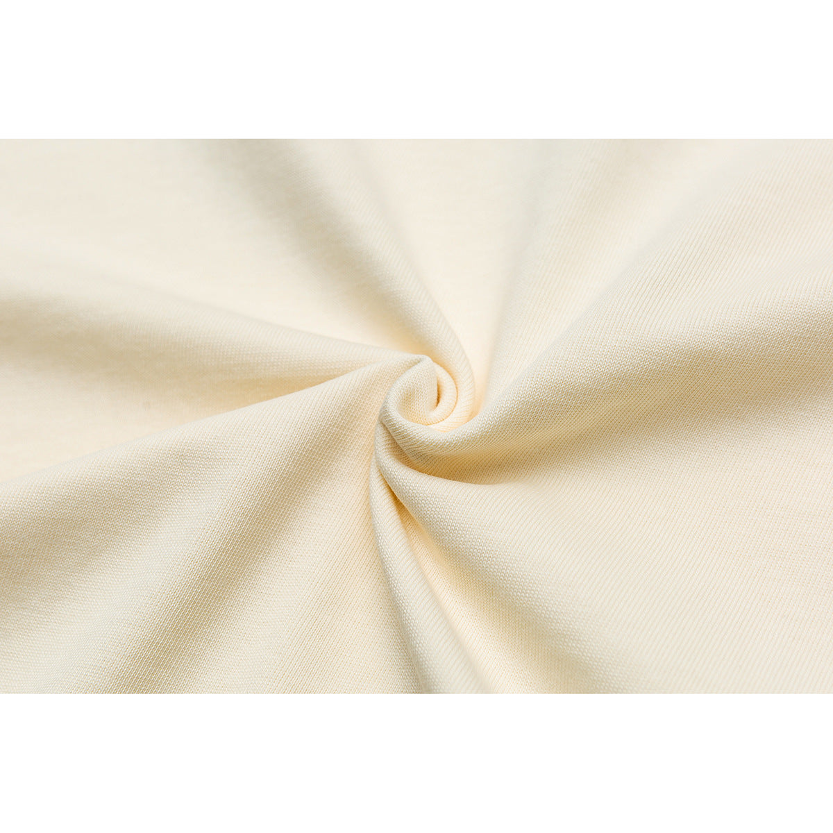 Close-up of ivory fabric gathered into a twist, showing its surface and drape.