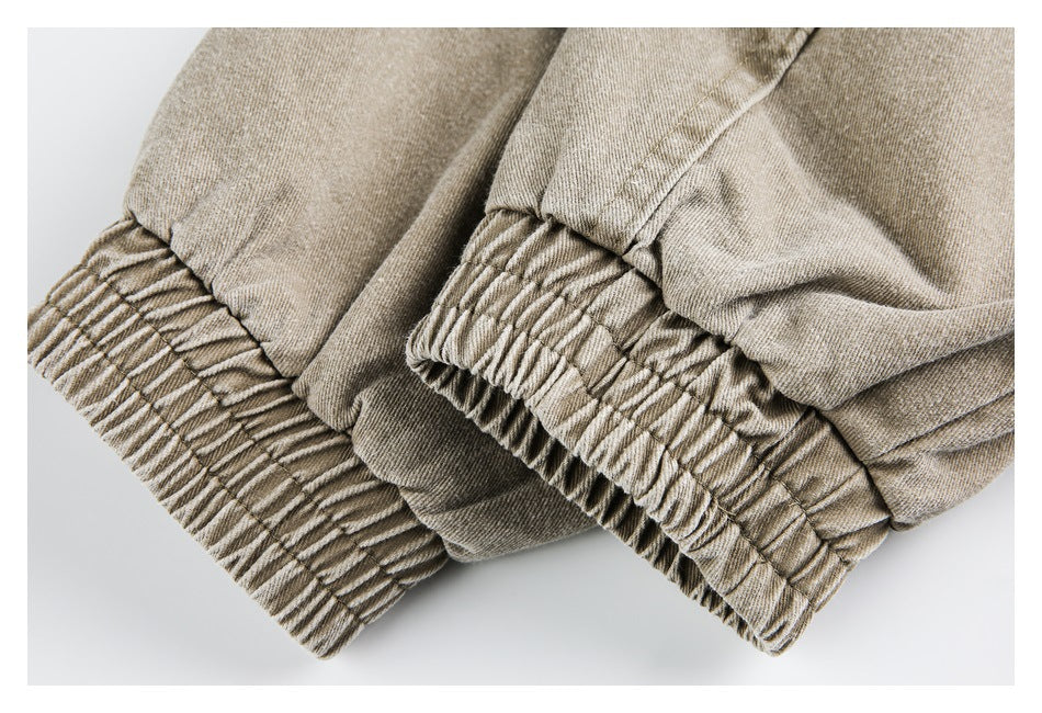 Close-up of gathered elastic cuffs on beige-tan pants.