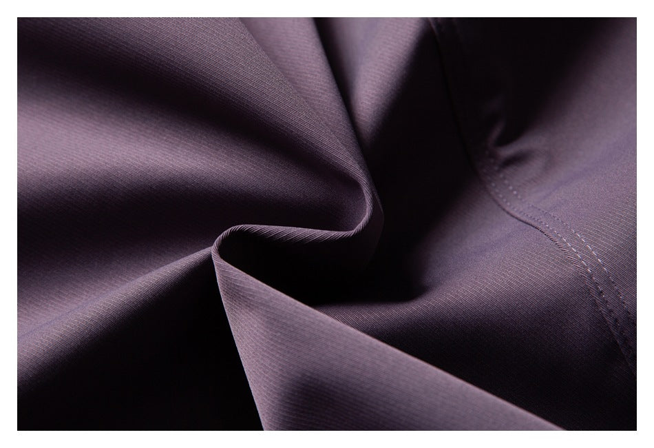 Close-up of purple garment fabric folds and a stitched seam.