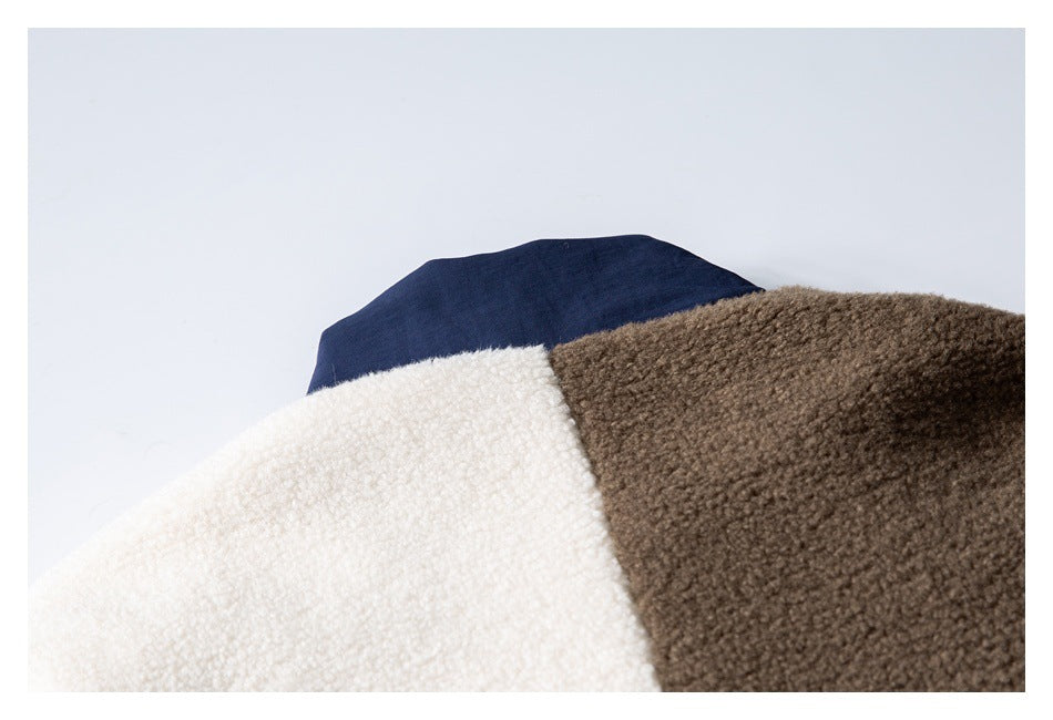 Close-up of cream, brown, and navy sections meeting on a fuzzy garment.