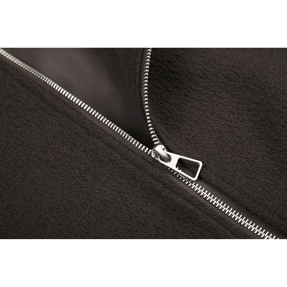 Close-up of a silver zipper on dark brown jacket fabric.