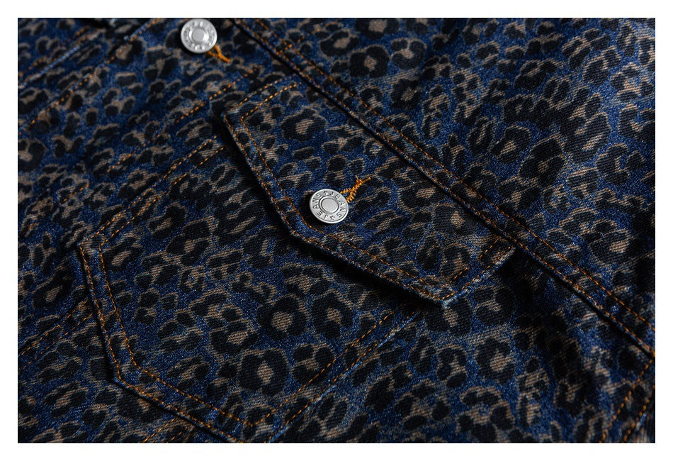 Close-up of the blue leopard-print denim jacket front, showing a flap pocket and silver buttons.