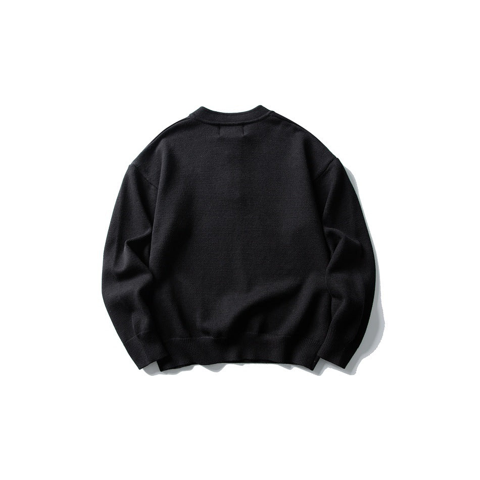 Back view of black knit sweater with ribbed cuffs and hem, flat lay