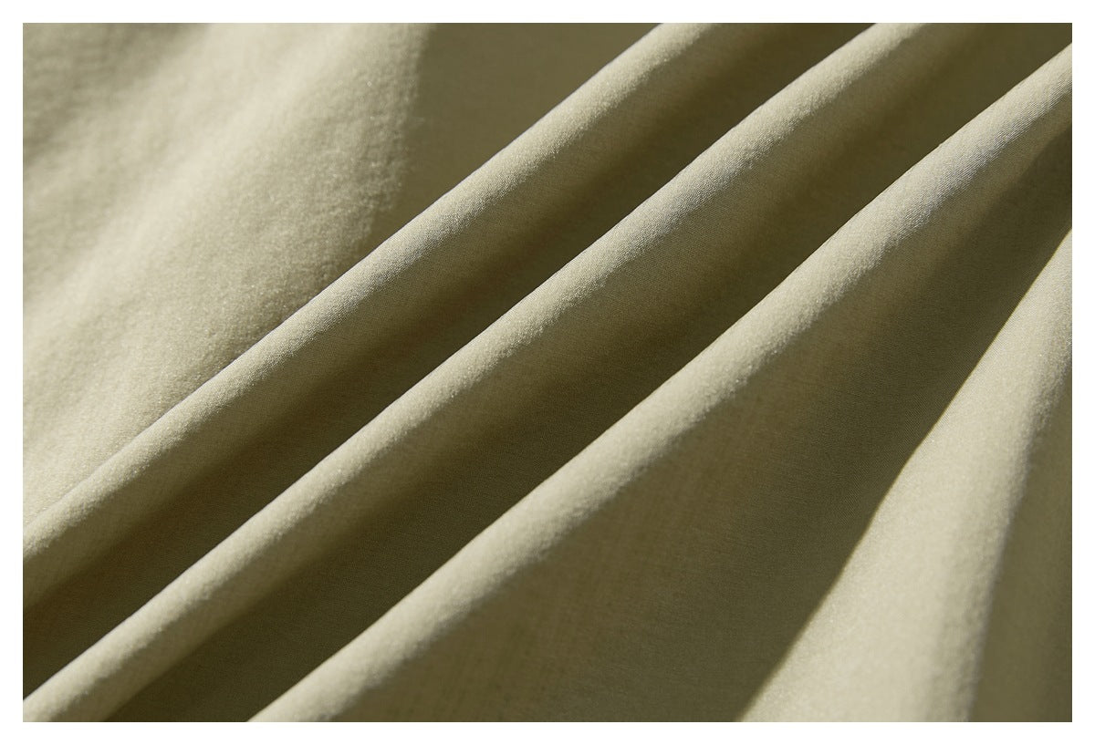 Close-up of khaki jacket fabric draped into soft folds.