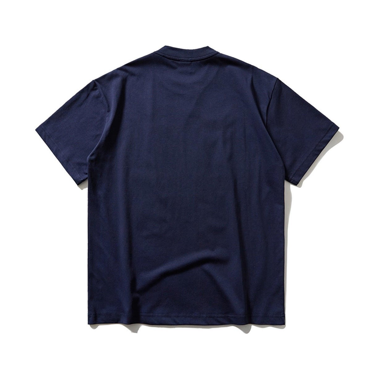 Back view of a plain navy short-sleeve crew-neck T-shirt laid flat