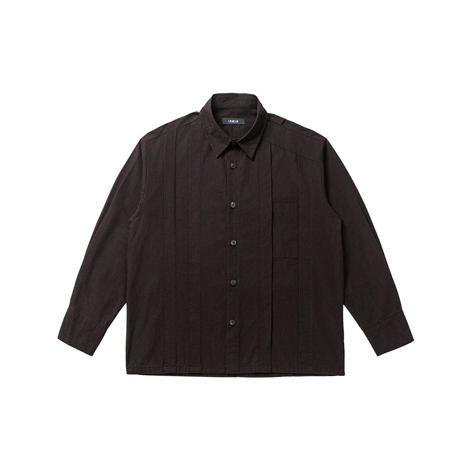Black long-sleeve button-up shirt with pleated front panels and chest pocket, flat lay on white background
