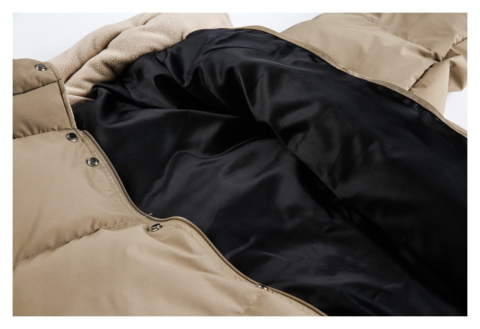 Close-up of a beige jacket opened to show its smooth black lining, snap fasteners, zipper, and fleece collar.