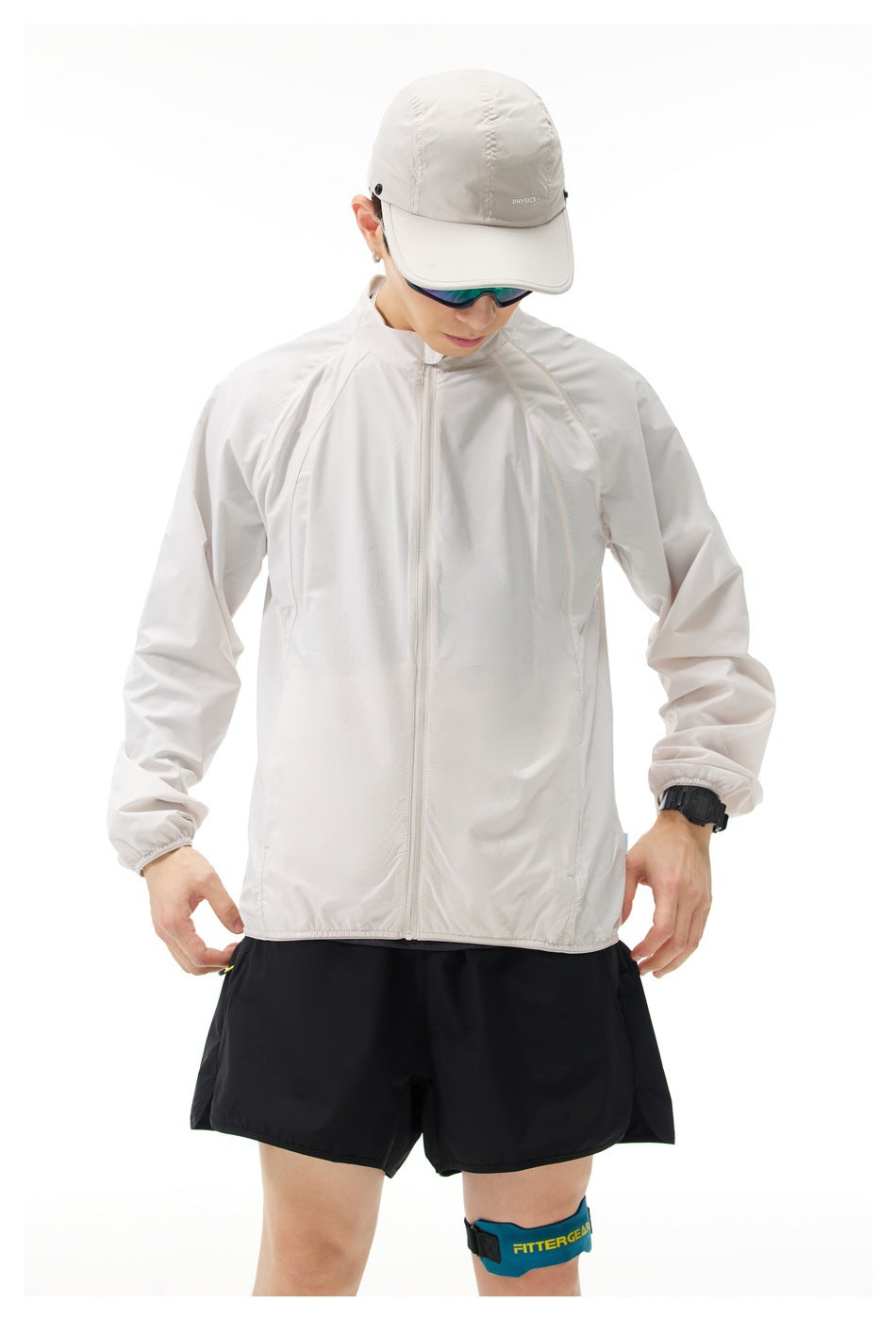 Model wearing a light gray full-zip jacket with a stand collar, raglan sleeves, and elastic cuffs, shown from the front.
