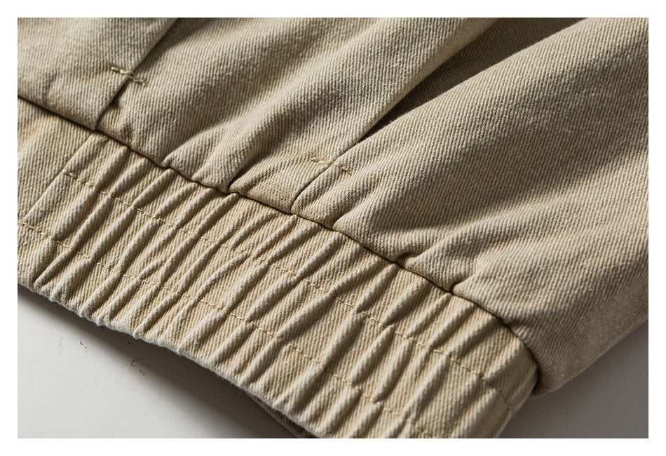 Close-up of a gathered, elasticized hem on beige twill fabric.
