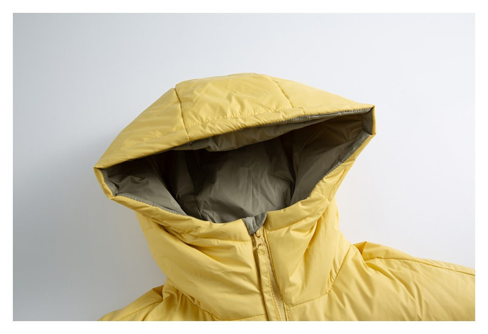 Close-up of the jacket’s large yellow hood, showing its gray lining and front zipper.