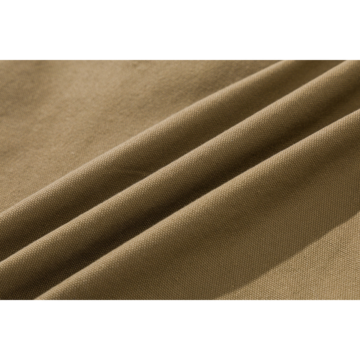 Extreme close-up of tan fabric folded to show its woven surface texture.