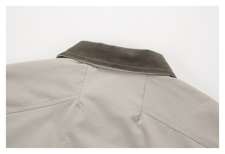 Close-up of the back collar and shoulder seams of a light taupe garment; the collar is dark brown.