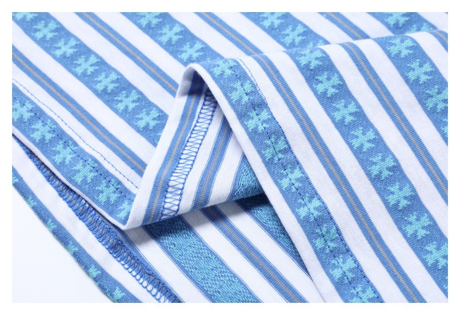 Close-up of the blue overlocked seam and folded edge of a blue-and-white patterned shirt.