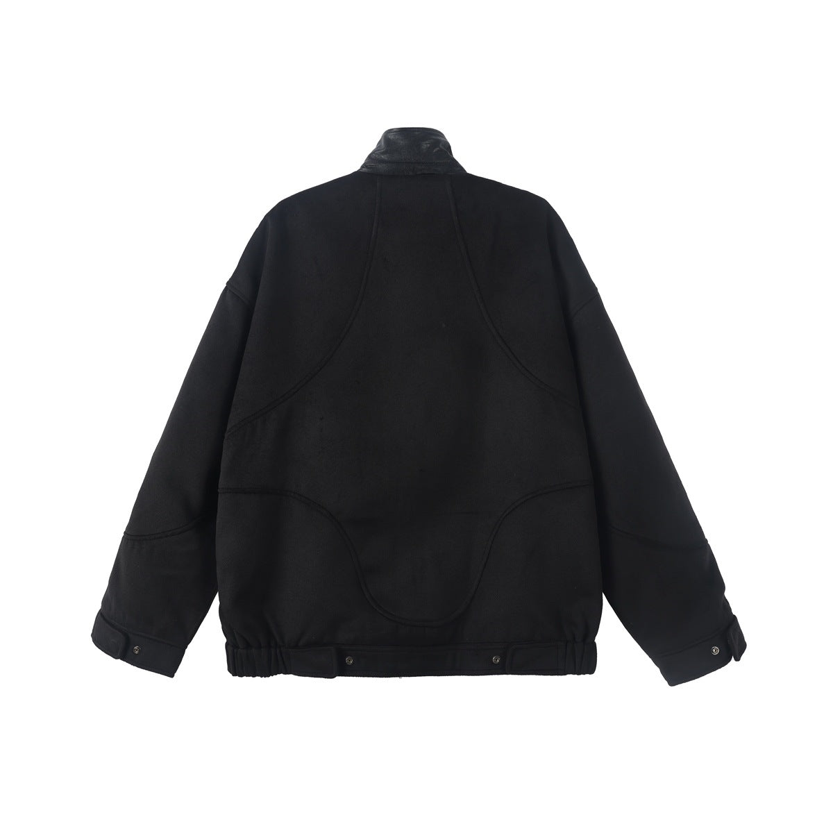 Black oversized jacket back view with curved seam panels, snap tabs at cuffs and elastic hem, flat lay