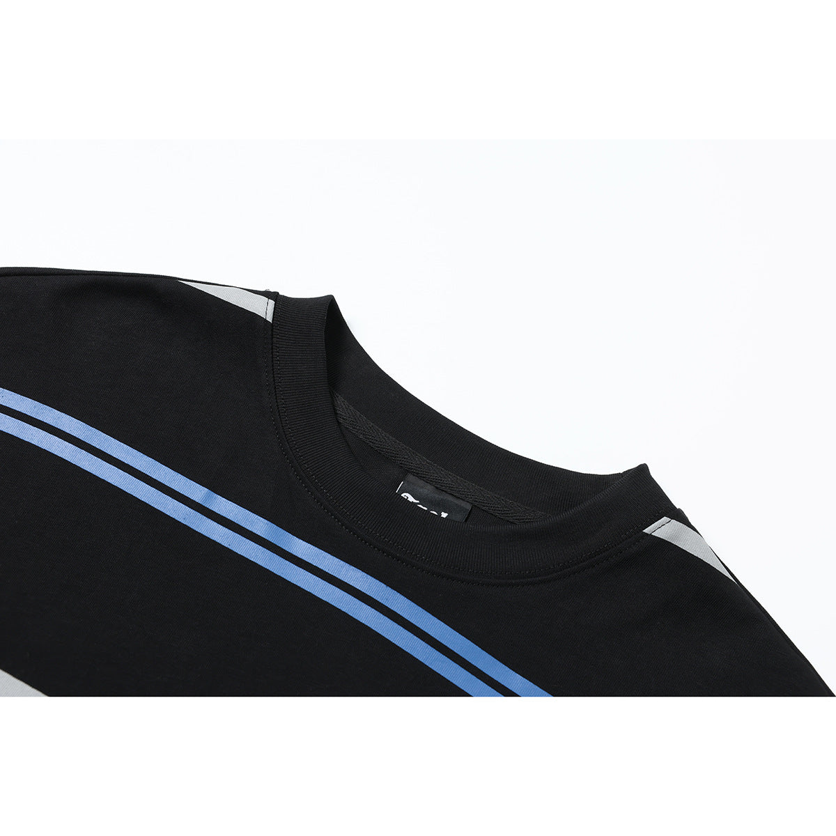 Close-up of a black crew-neck shirt with blue and white stripes across the shoulder and chest.