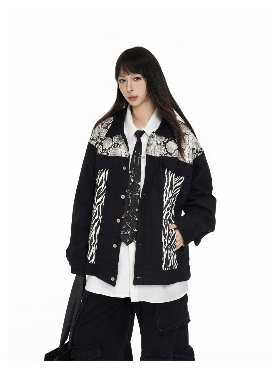 Closer front view of a model wearing a black jacket with snakeskin-patterned shoulders, zebra-print panels and silver