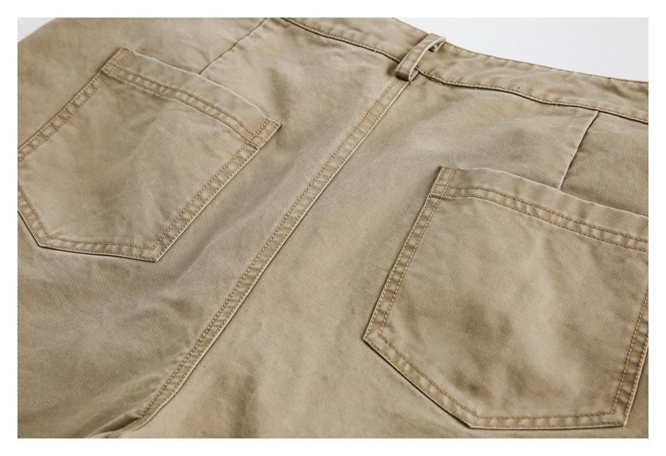 Partial flat-lay back view of tan trousers with two patch pockets and a belt loop.