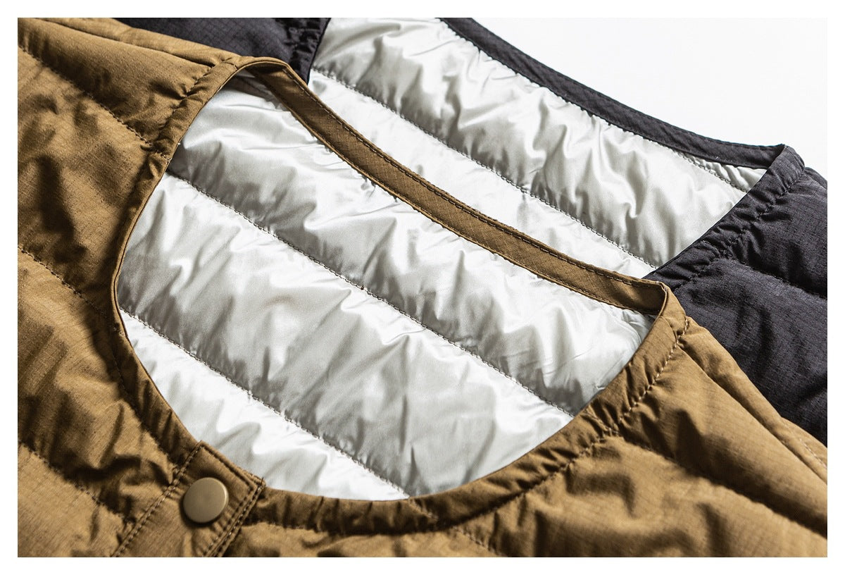 Close-up of a brown quilted jacket showing its pale padded lining, dark trim, and a snap button.