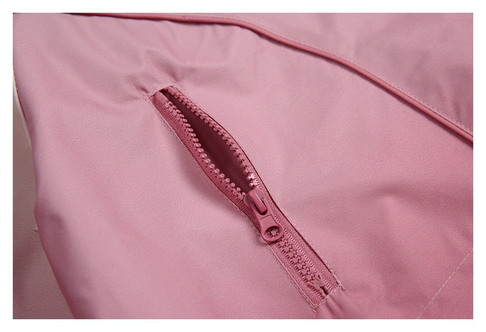 Close-up of an open pink zipper pocket on the pale pink jacket.