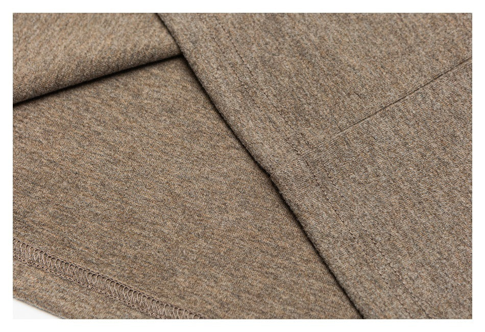 Close-up of a stitched seam and overlocked edge on heathered taupe-brown fabric.