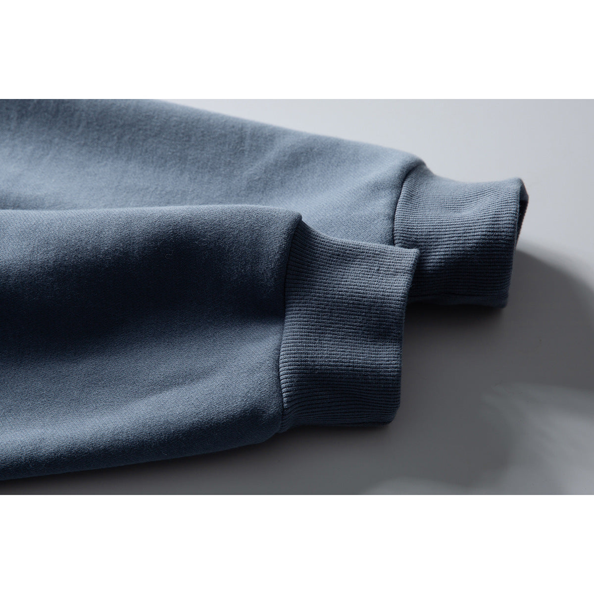 Close-up of the blue jacket's sleeve and wide ribbed cuff.