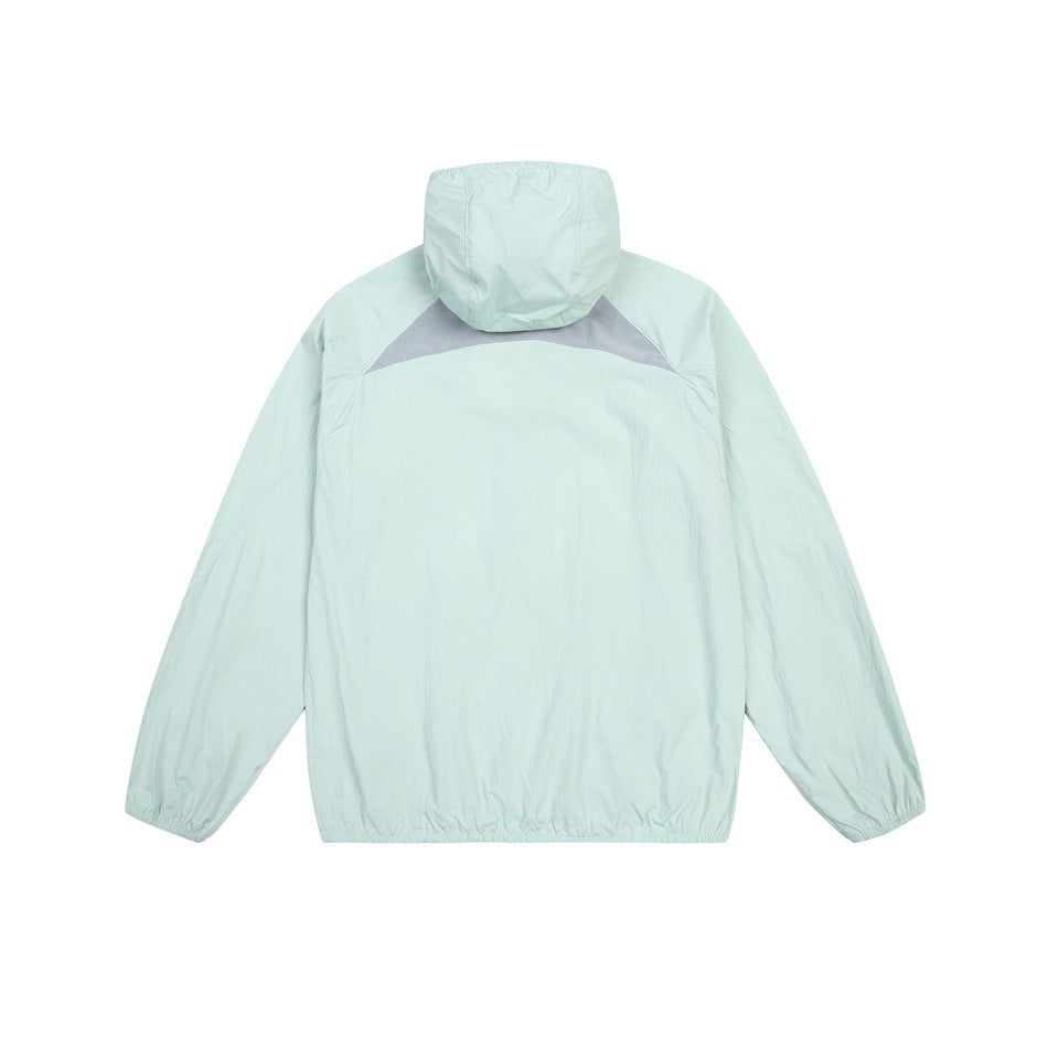 Back view of a mint hooded jacket with a gray triangular upper-back panel and elasticized cuffs and hem.