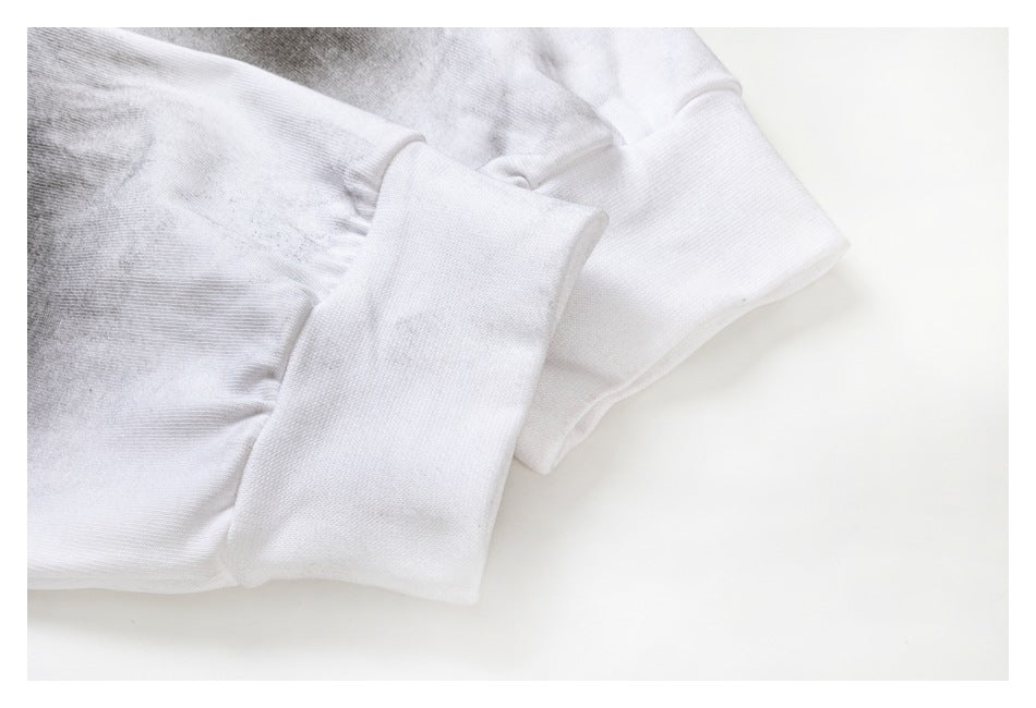 Close-up of the white shirt's long sleeve and wide cuff, with gray tie-dye near the seam.