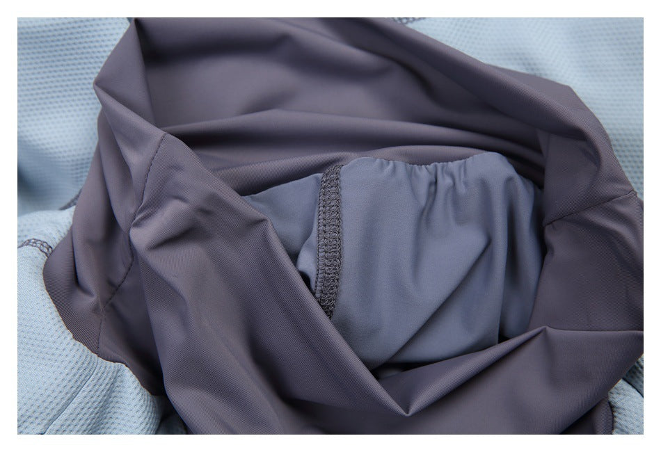 Interior close-up showing charcoal-gray fabric panels, a blue-gray lining section, and stitched seams.