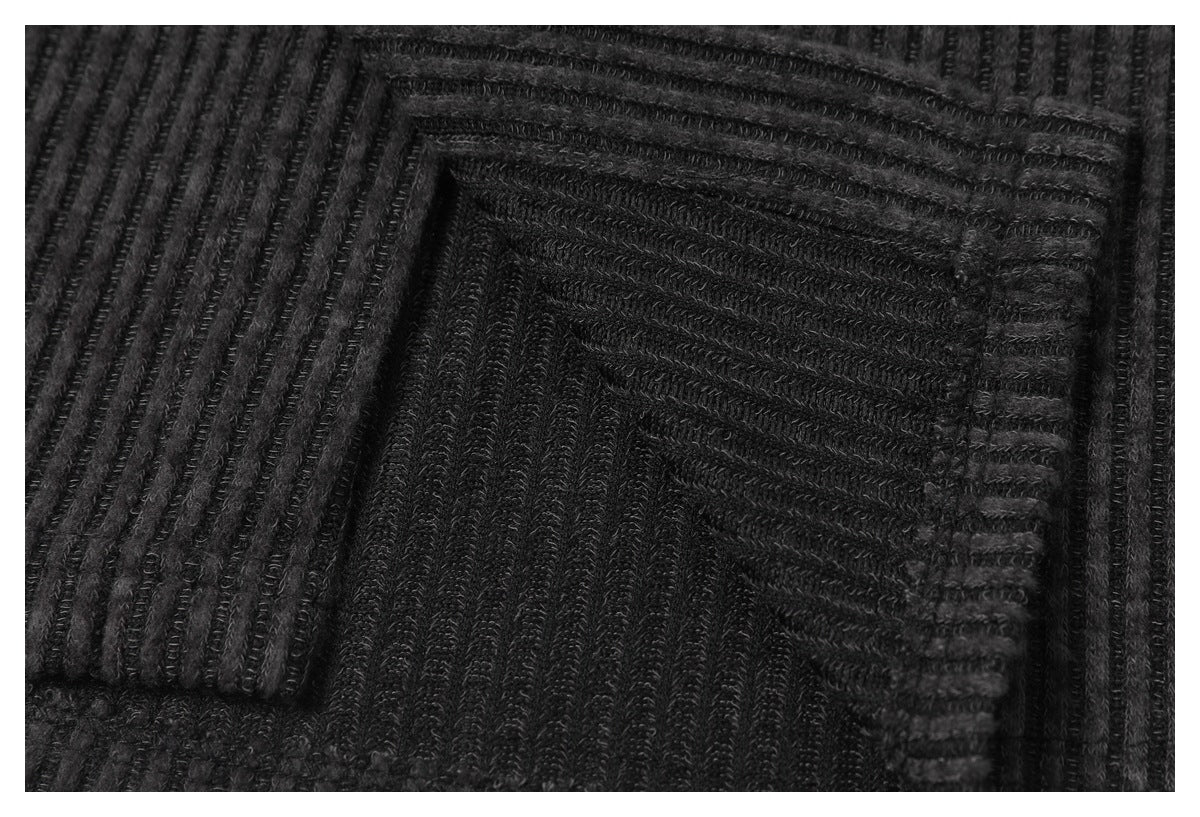 Close-up of a patch pocket on the dark charcoal shirt, showing its ribbed fabric and stitching.