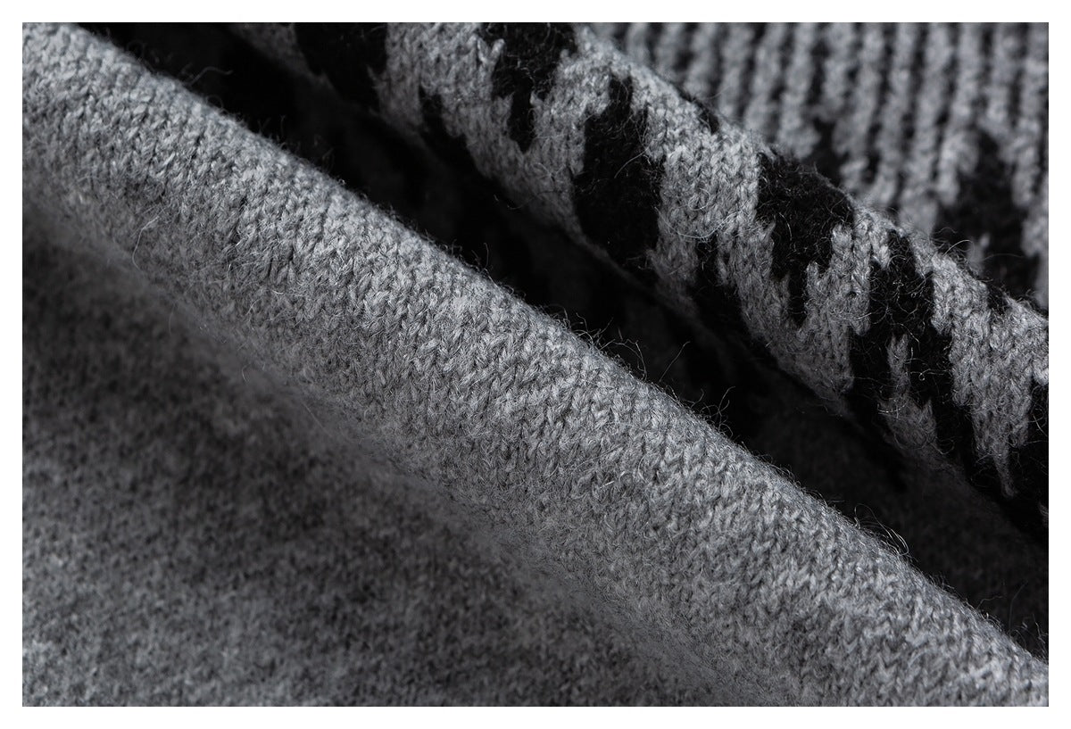 Close-up of soft gray knit fabric folded over a black-and-gray patterned section.